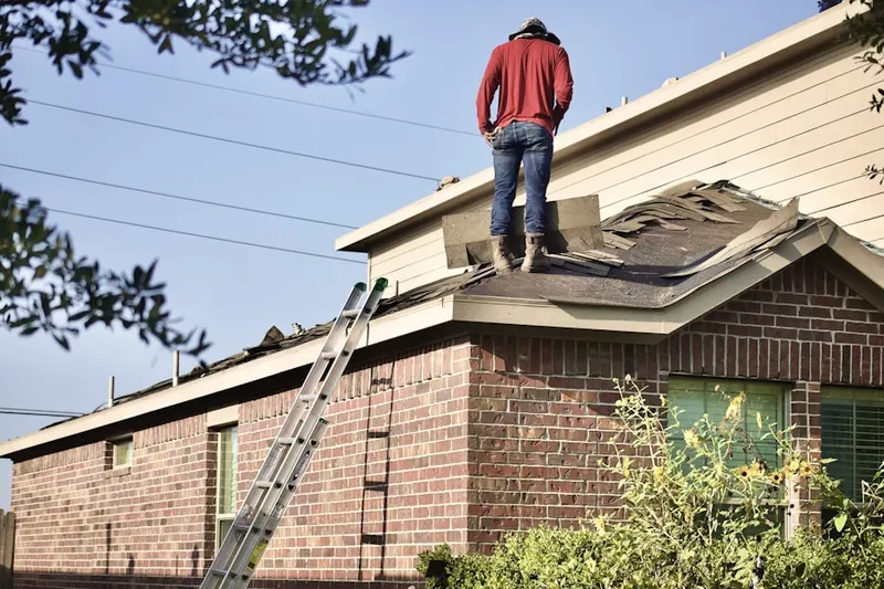 Professional roofer working on a residential roof in Swedetown Village